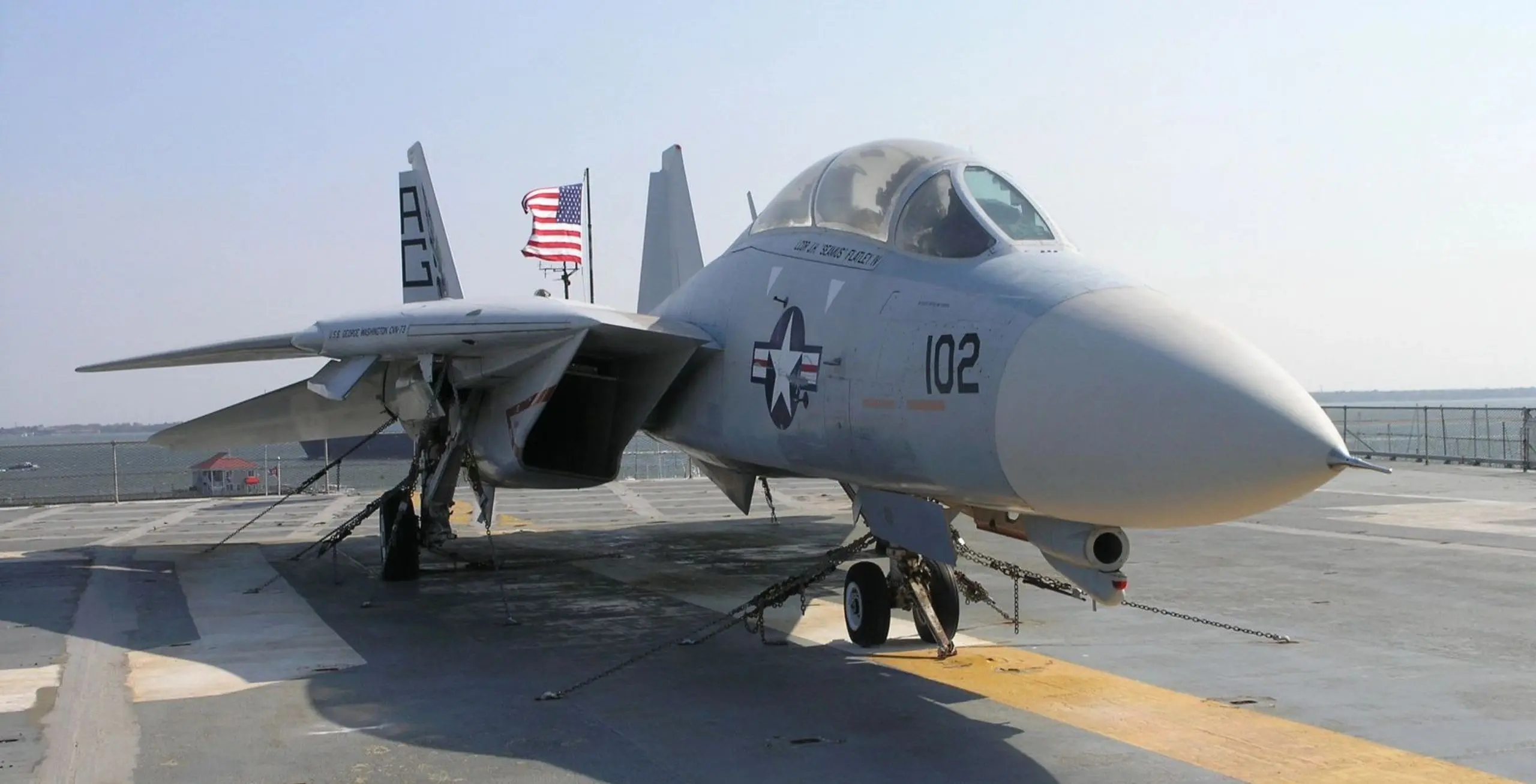 A fighter jet sitting on top of an airport runway.