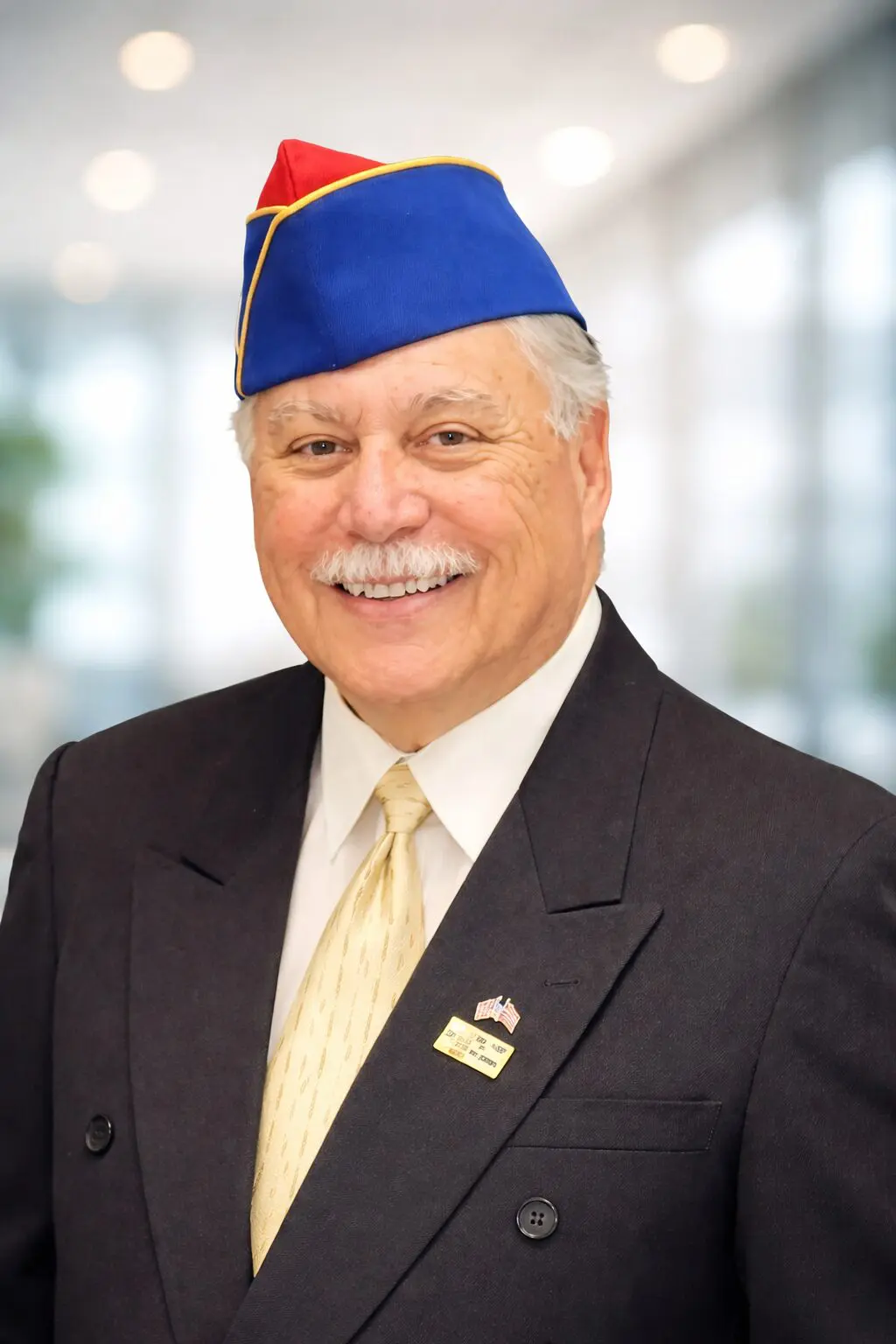 Smiling veteran in blue and red cap