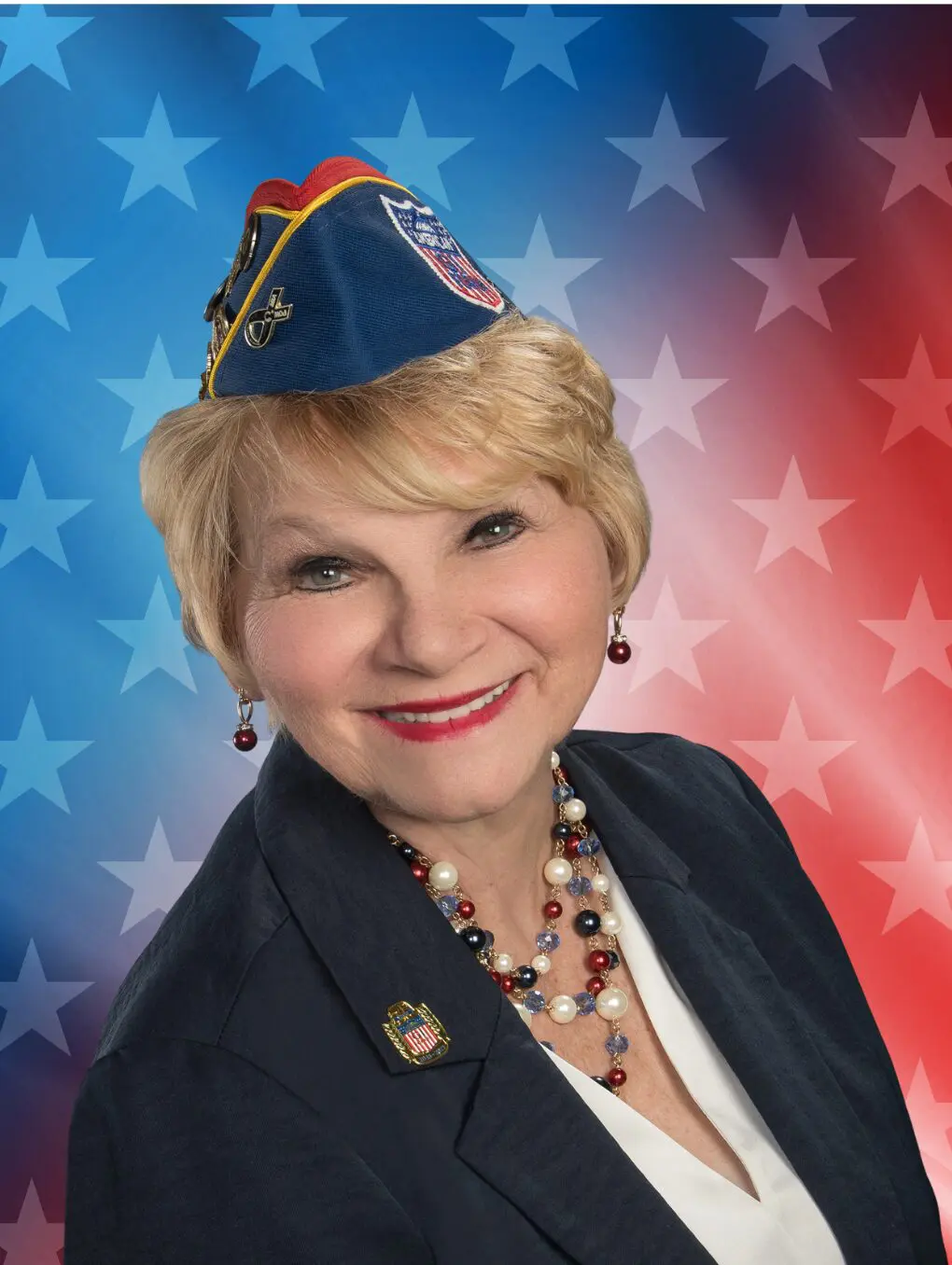 Smiling woman wearing veterans cap, star background