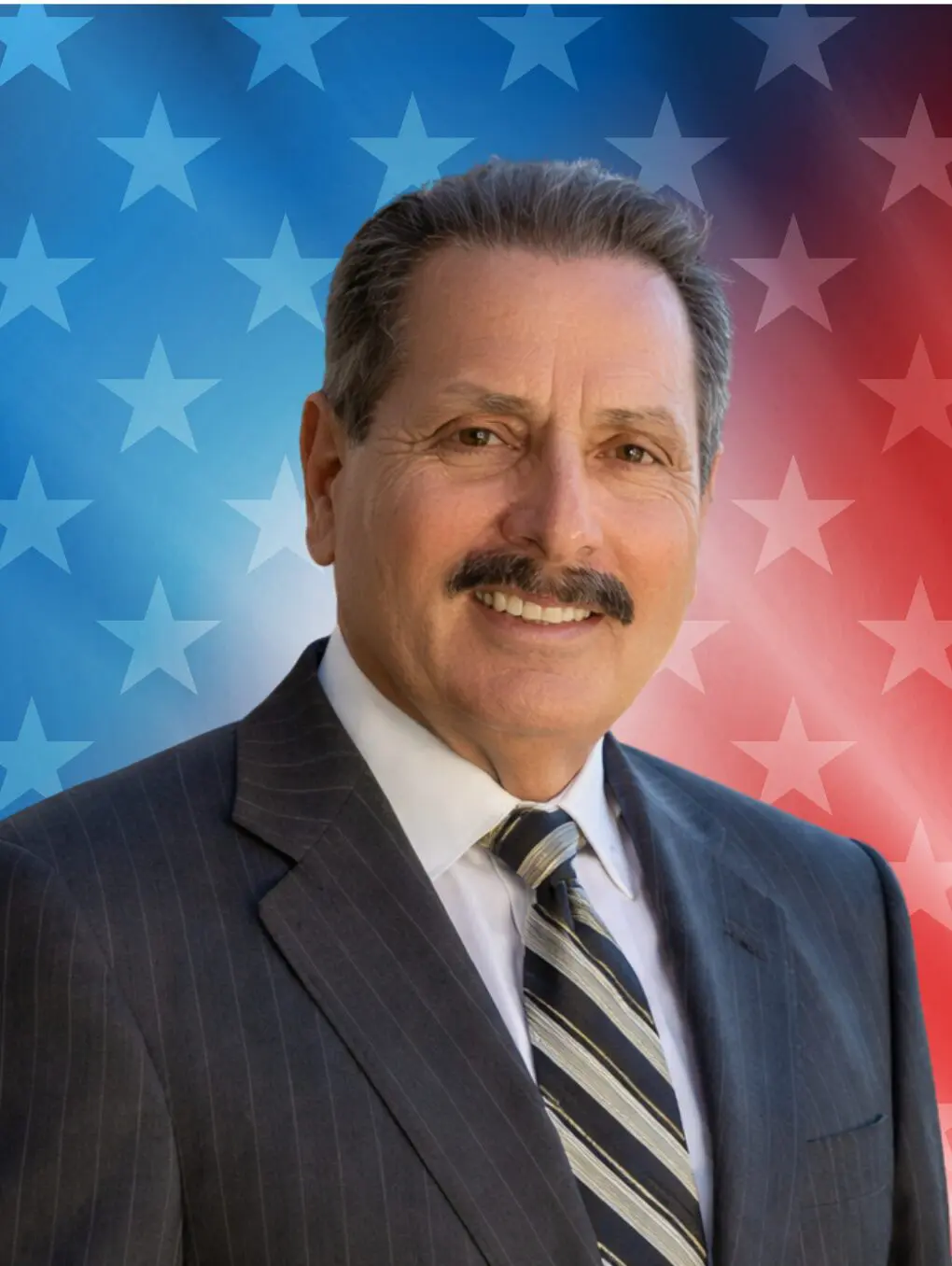 Smiling man in suit, American flag background