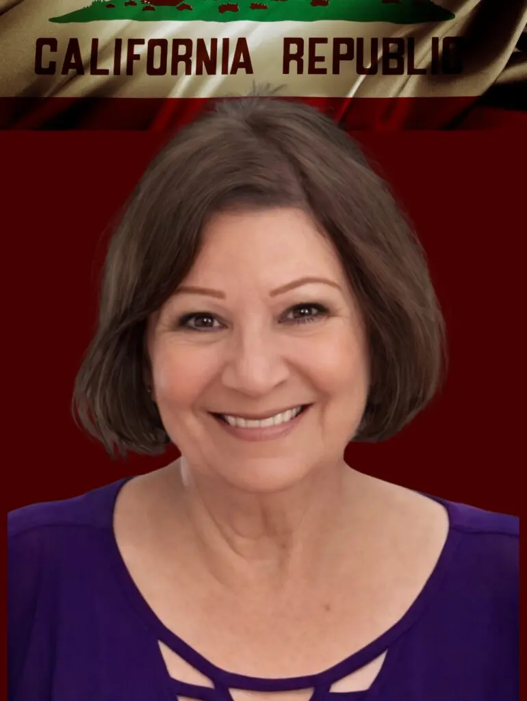 Smiling woman in purple top, California flag