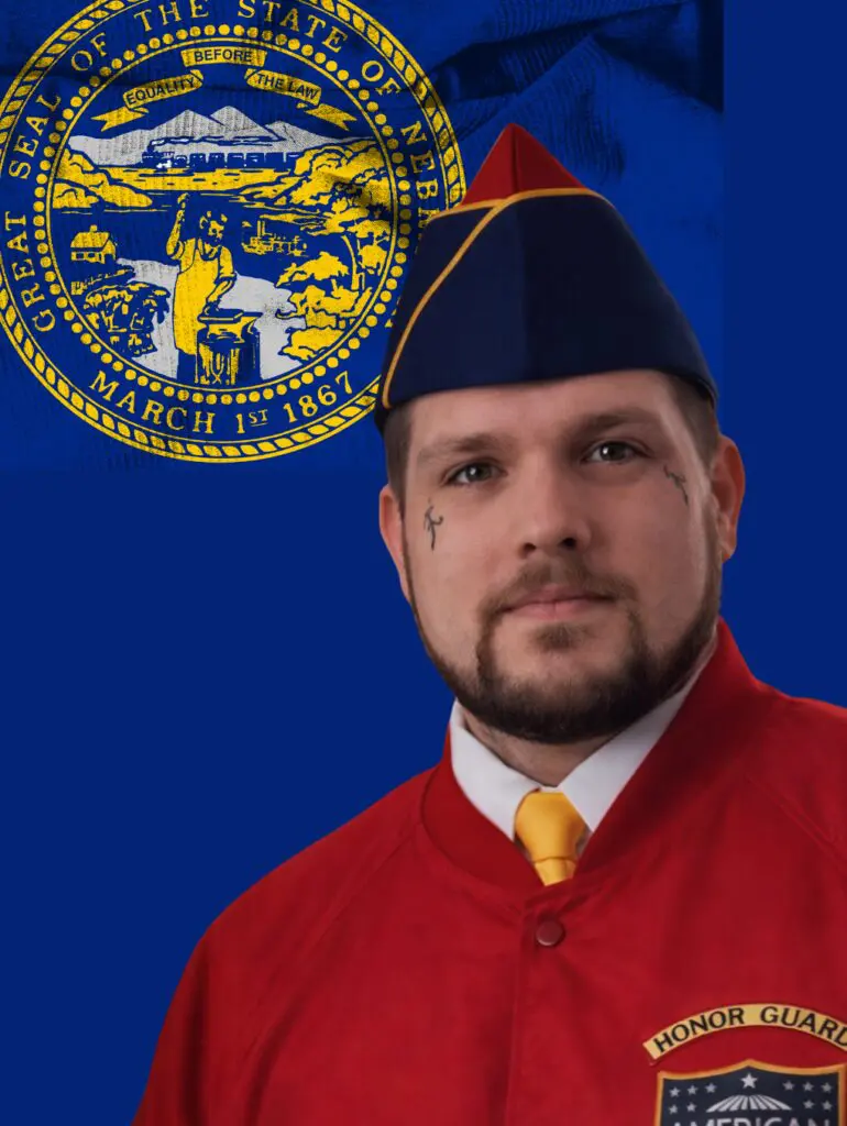 Honor guard in red uniform with Nebraska seal